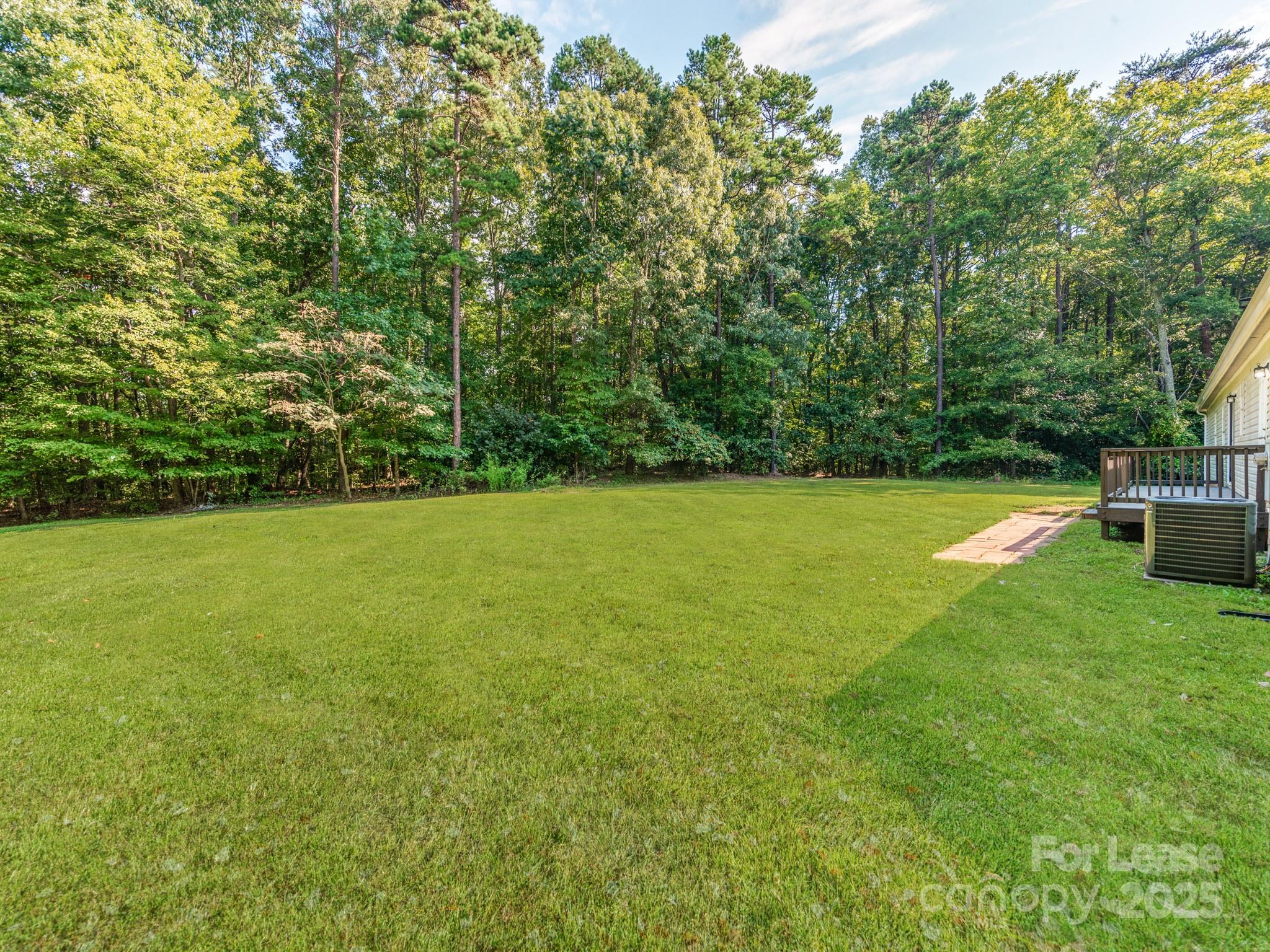 1219 Foxlaire Drive Denver, NC 28037 - Photo 26 of 30 a view of a field with plants and trees in the background