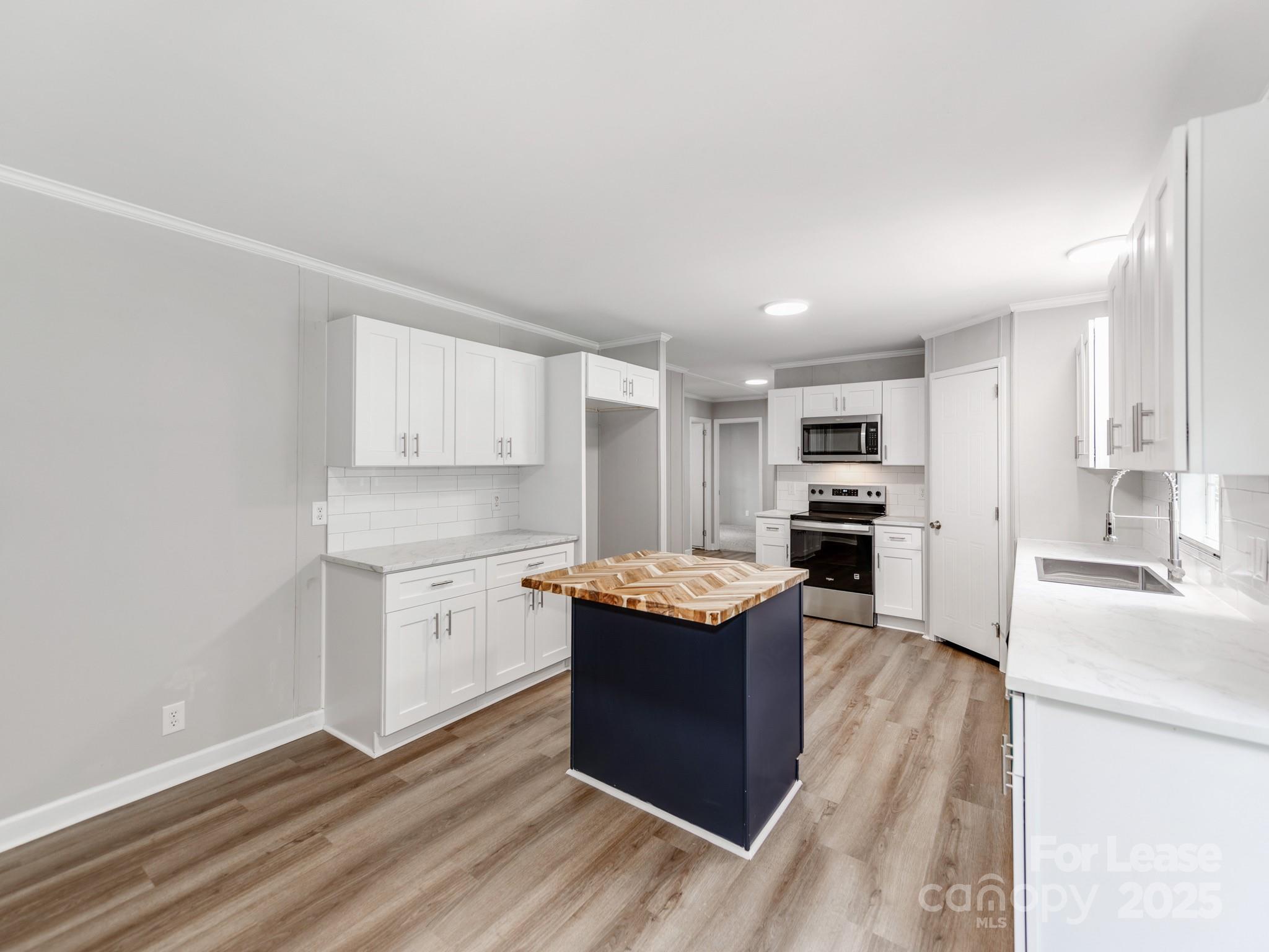 1219 Foxlaire Drive Denver, NC 28037 - Photo 8 of 30 a kitchen with stainless steel appliances granite countertop a sink stove and refrigerator