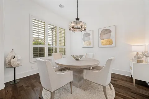 a view of a dining room with furniture wooden floor and chandelier