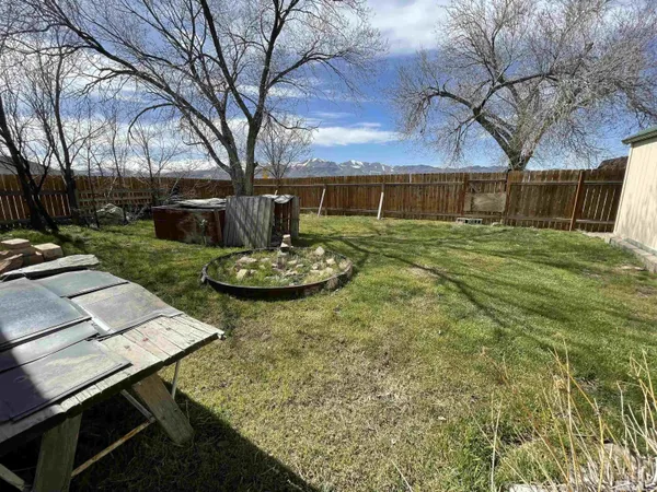 a view of a backyard with sitting area
