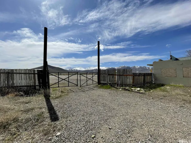 a backyard of a house with a table and chairs