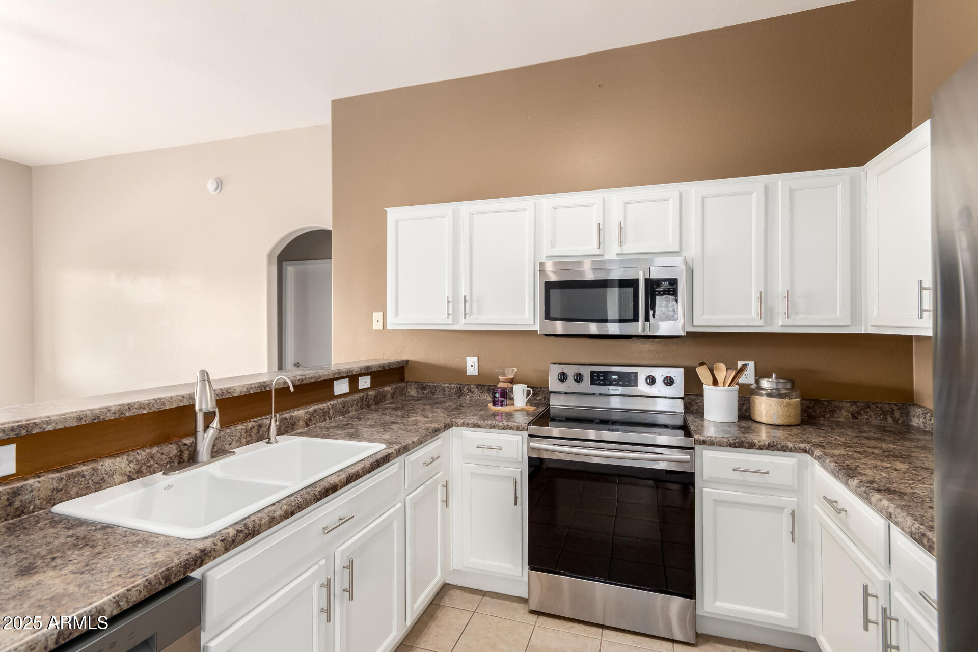 16620 South 48th Street, Unit 70 Phoenix, AZ 85048 - Photo 16 of 36 a kitchen with stainless steel appliances granite countertop a sink stove and microwave