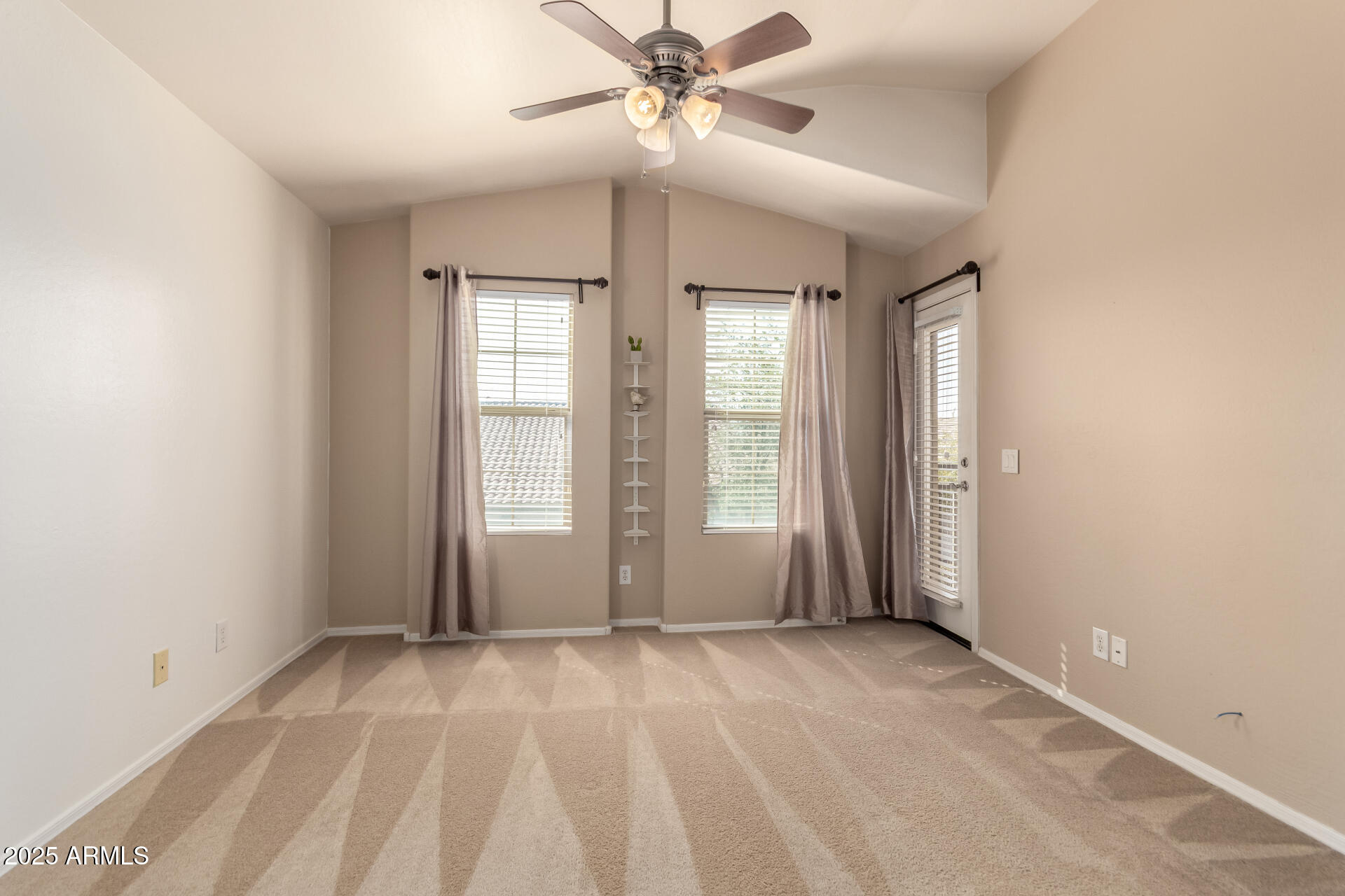 16620 South 48th Street, Unit 70 Phoenix, AZ 85048 - Photo 19 of 36 an empty room with windows and fan