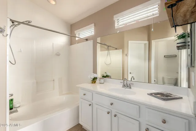 an empty room with closet and a chandelier fan