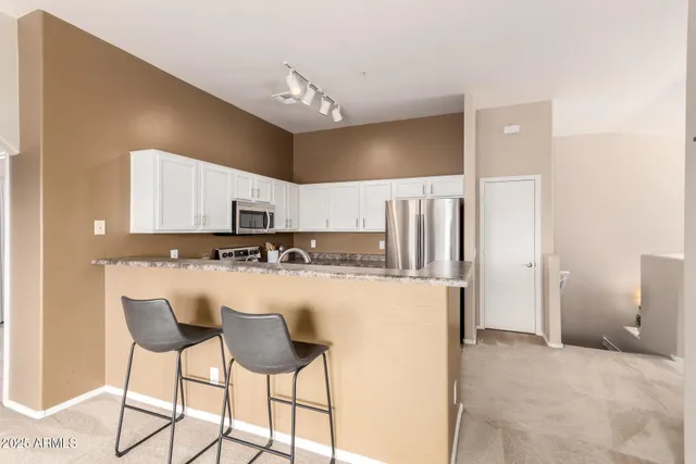 a kitchen with stainless steel appliances a refrigerator and a stove