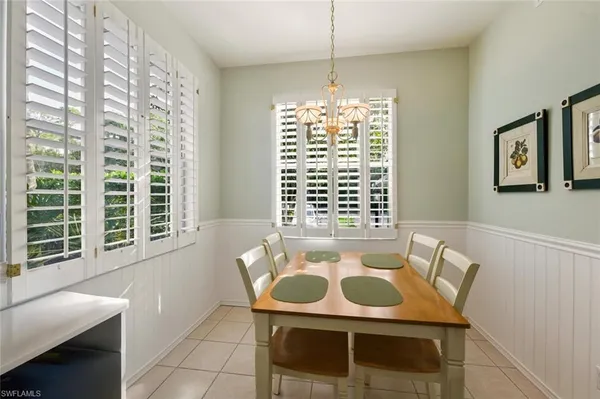 a dining room with furniture and window