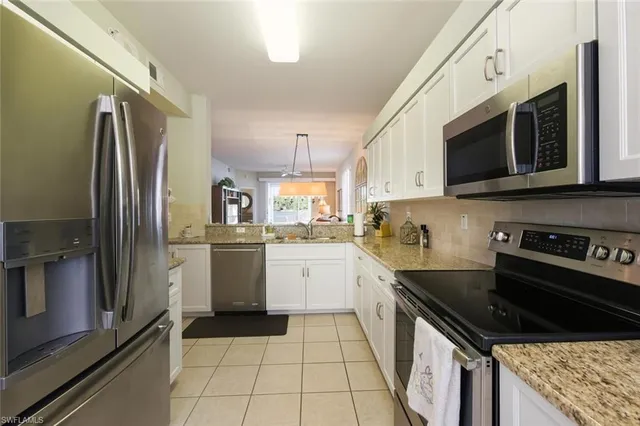 a kitchen with a sink stove and refrigerator