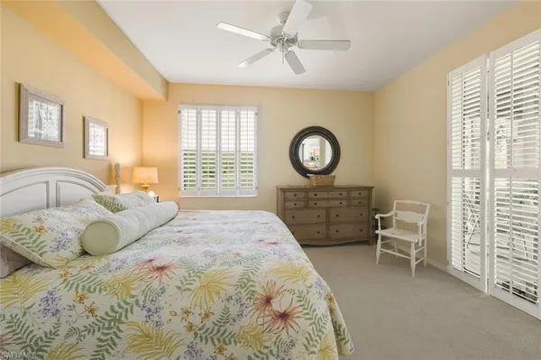 a bedroom with a bed a dresser and chair