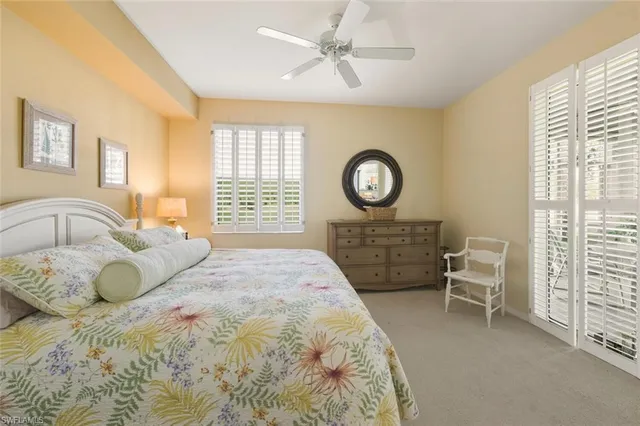 a bedroom with a bed a dresser and chair