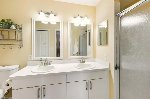 a bathroom with a sink double vanity and a mirror