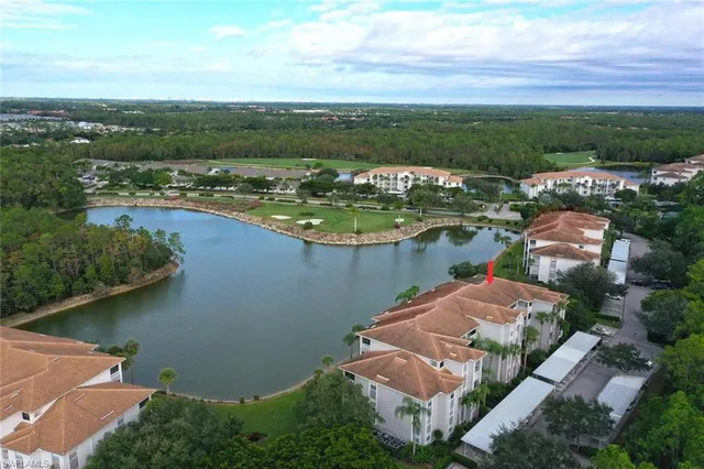 an aerial view of residential houses with outdoor space and ocean view