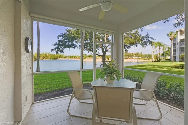 a view of a patio with a table chairs and a backyard