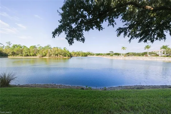 a view of a lake with houses in the background