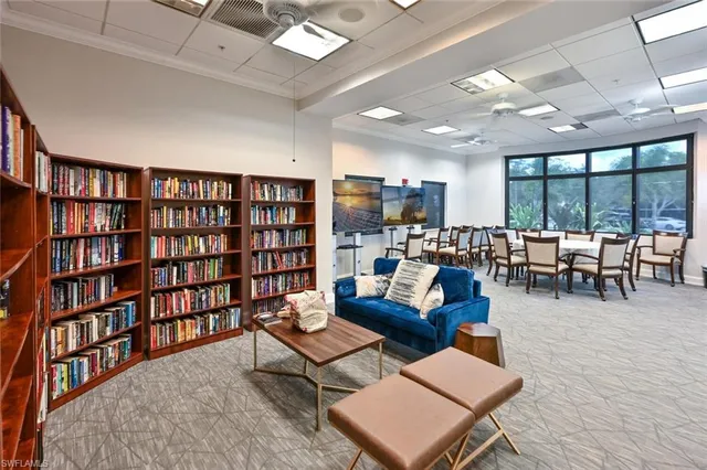 a living room with furniture and a book shelf