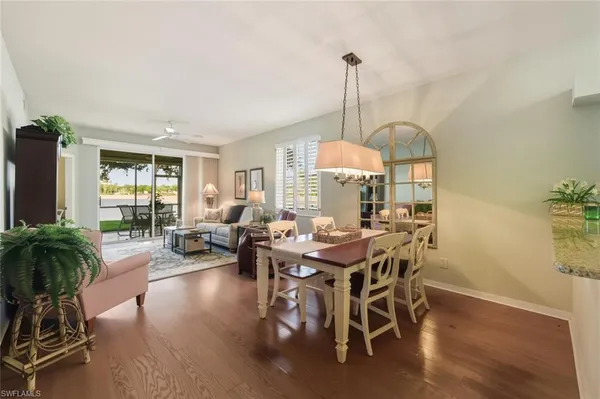 a view of a livingroom with furniture window and wooden floor