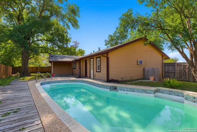 a backyard of a house with table and chairs