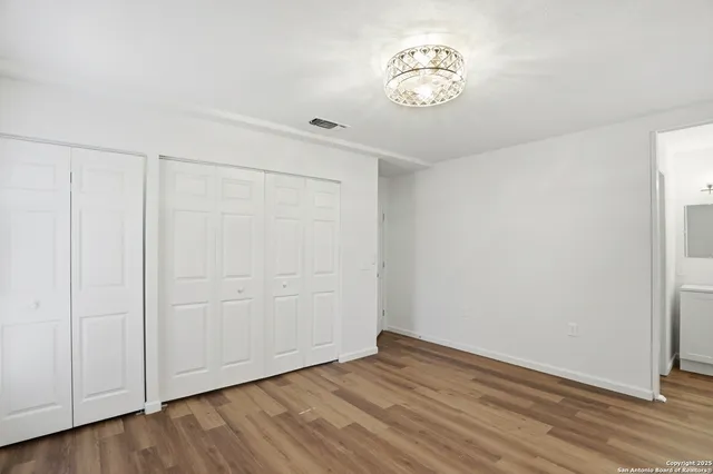 a view of a room with wooden floor
