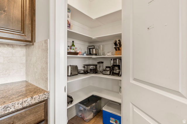 4257 Razor Drive Washington, UT 84780 - Photo 29 of 58 Expansive walk-in pantry with wrap-around white shelving, offering significant storage capacity