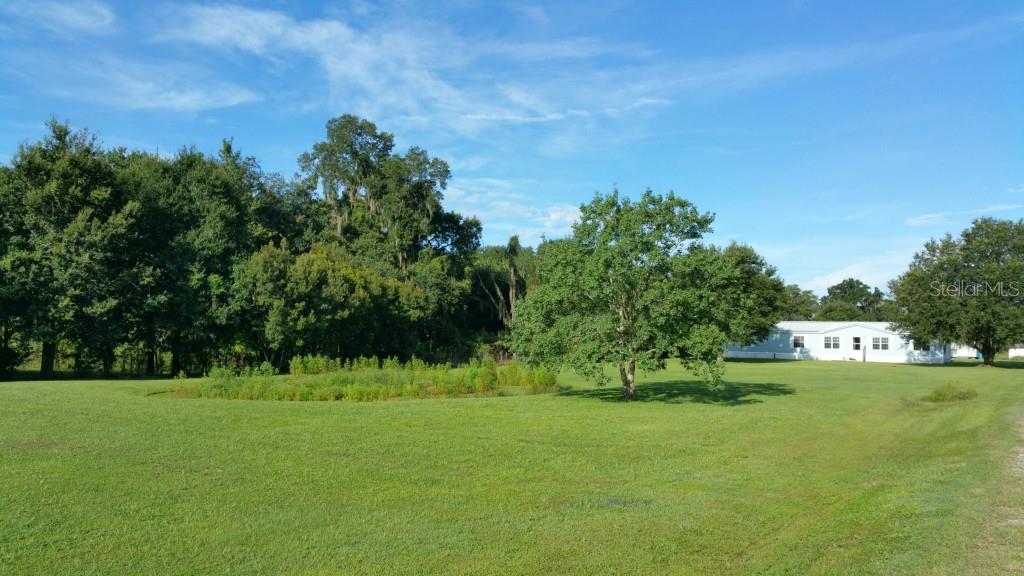 Front view.  Home is nestled to the rear of the property for privacy.