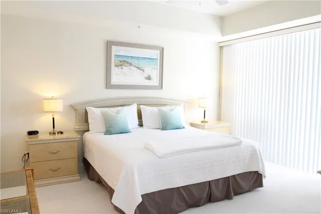 a bedroom with a bed and lamp with window