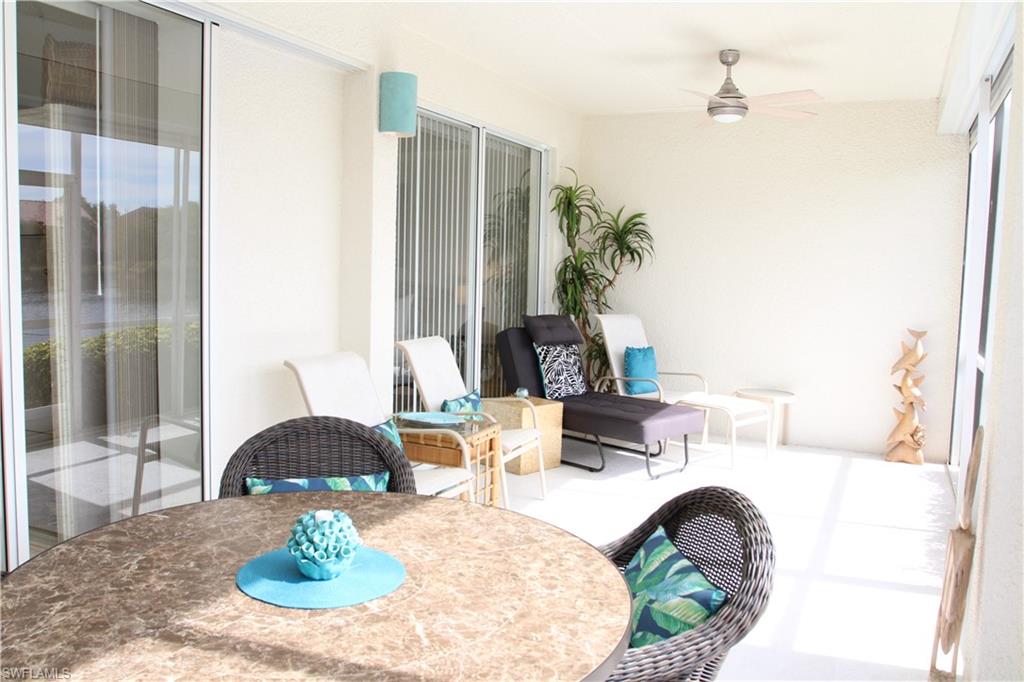 6660 Beach Resort Drive, Unit 1005 Naples, FL 34114 - Photo 14 of 38 a living room with furniture and a table