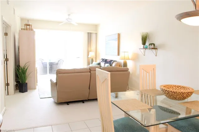 a living room with furniture a table and a large window