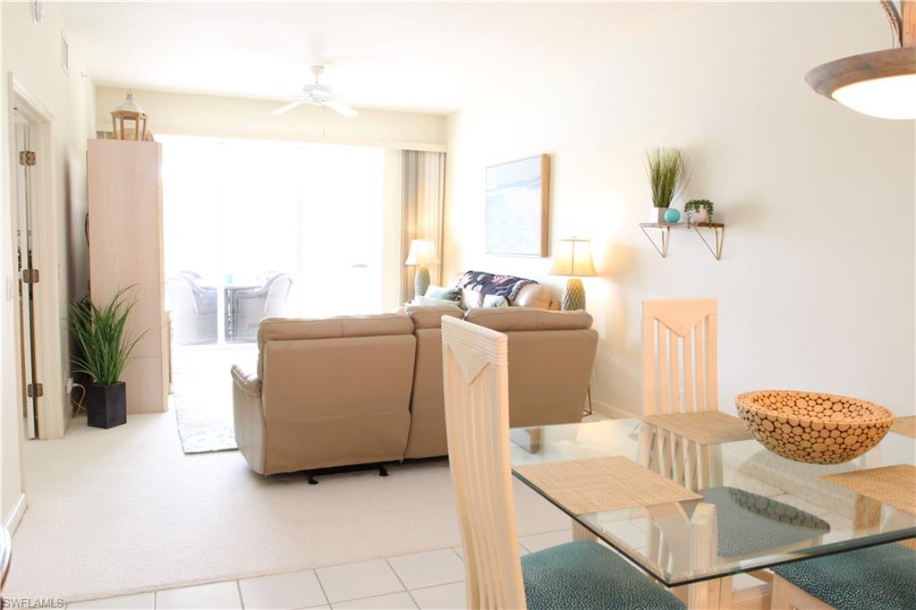 6660 Beach Resort Drive, Unit 1005 Naples, FL 34114 - Photo 15 of 38 a living room with furniture and a table