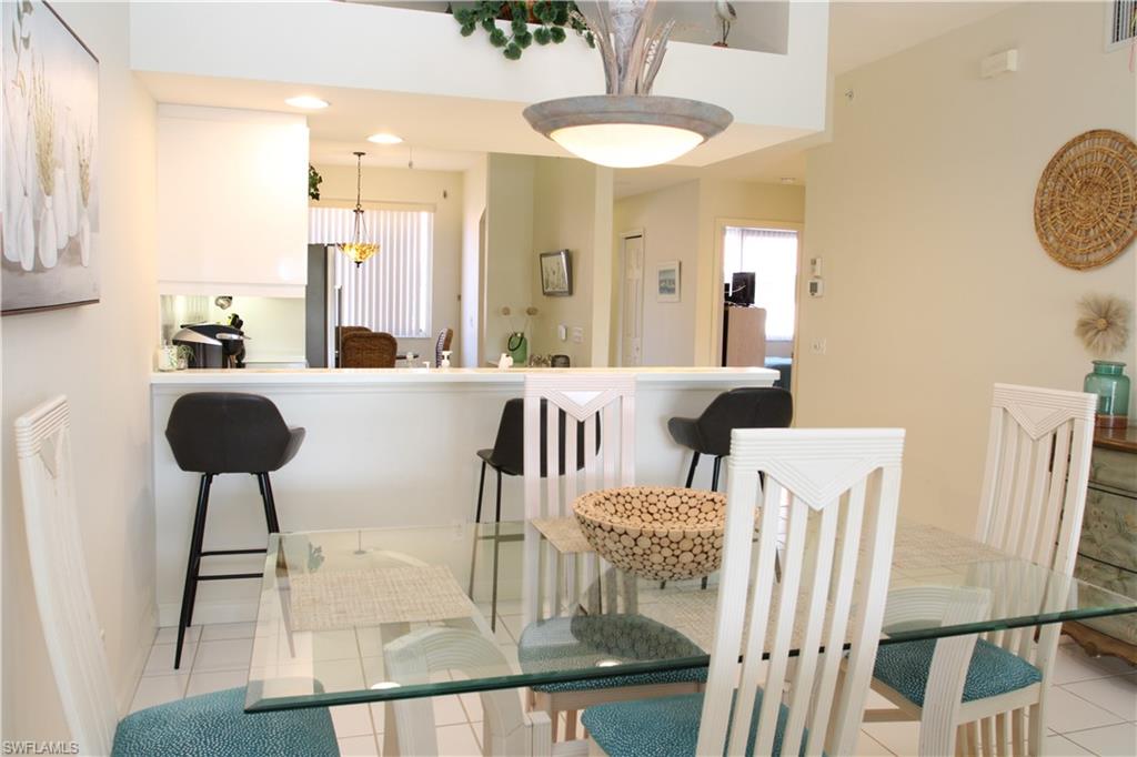 6660 Beach Resort Drive, Unit 1005 Naples, FL 34114 - Photo 17 of 38 a living room with furniture and a chandelier
