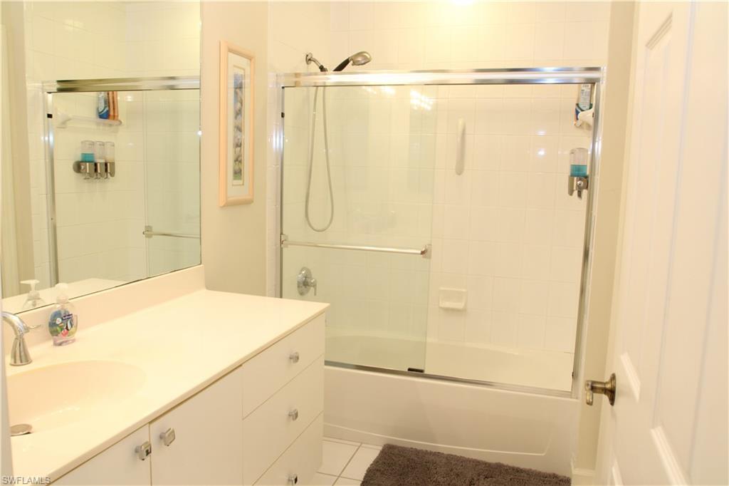 6660 Beach Resort Drive, Unit 1005 Naples, FL 34114 - Photo 22 of 38 a bathroom with a shower and a sink