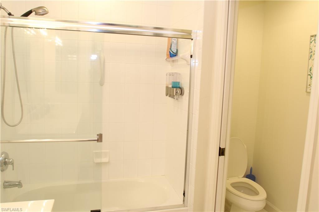 6660 Beach Resort Drive, Unit 1005 Naples, FL 34114 - Photo 23 of 38 a bathroom with a shower and a toilet