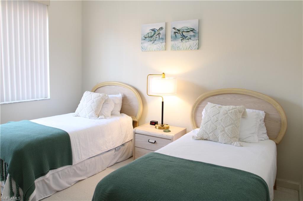 6660 Beach Resort Drive, Unit 1005 Naples, FL 34114 - Photo 25 of 38 a bedroom with two beds and painting on the wall
