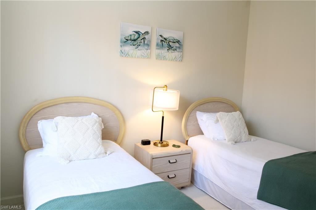 6660 Beach Resort Drive, Unit 1005 Naples, FL 34114 - Photo 27 of 38 a bedroom with a bed and a table