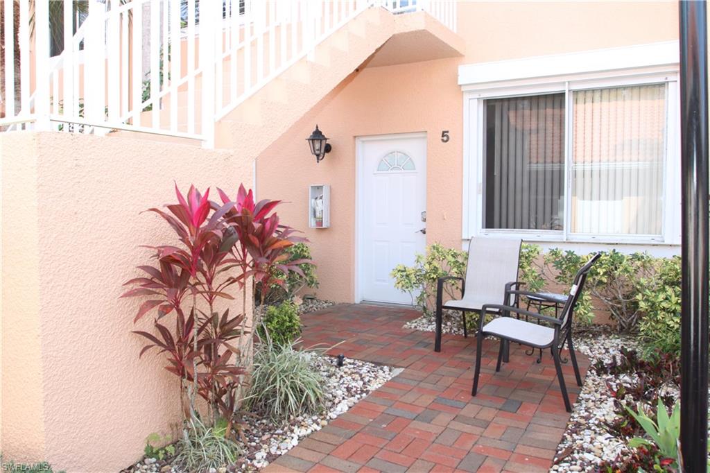6660 Beach Resort Drive, Unit 1005 Naples, FL 34114 - Photo 31 of 38 a front view of a house with garden