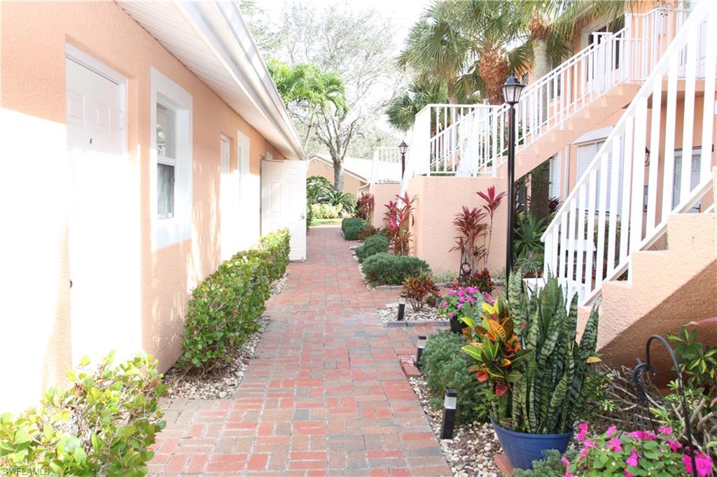 6660 Beach Resort Drive, Unit 1005 Naples, FL 34114 - Photo 34 of 38 a view of a pathway with house and flower plants