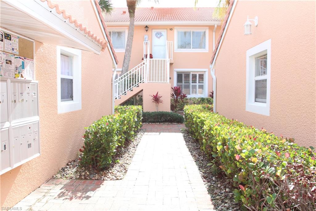 6660 Beach Resort Drive, Unit 1005 Naples, FL 34114 - Photo 35 of 38 a view of a house with a flower garden