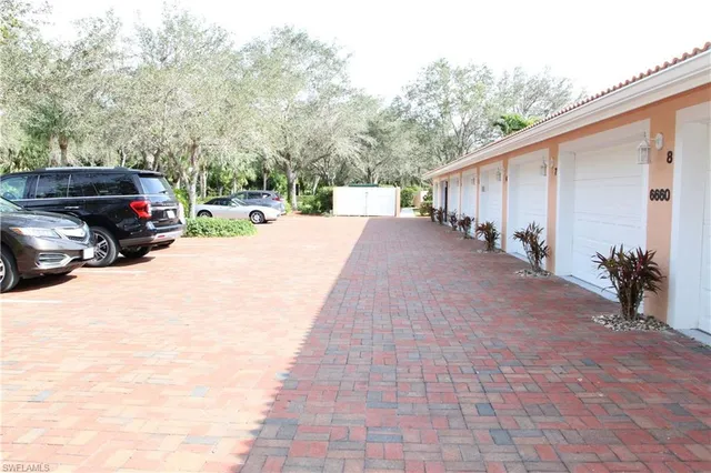 a view of a car park in front of a house