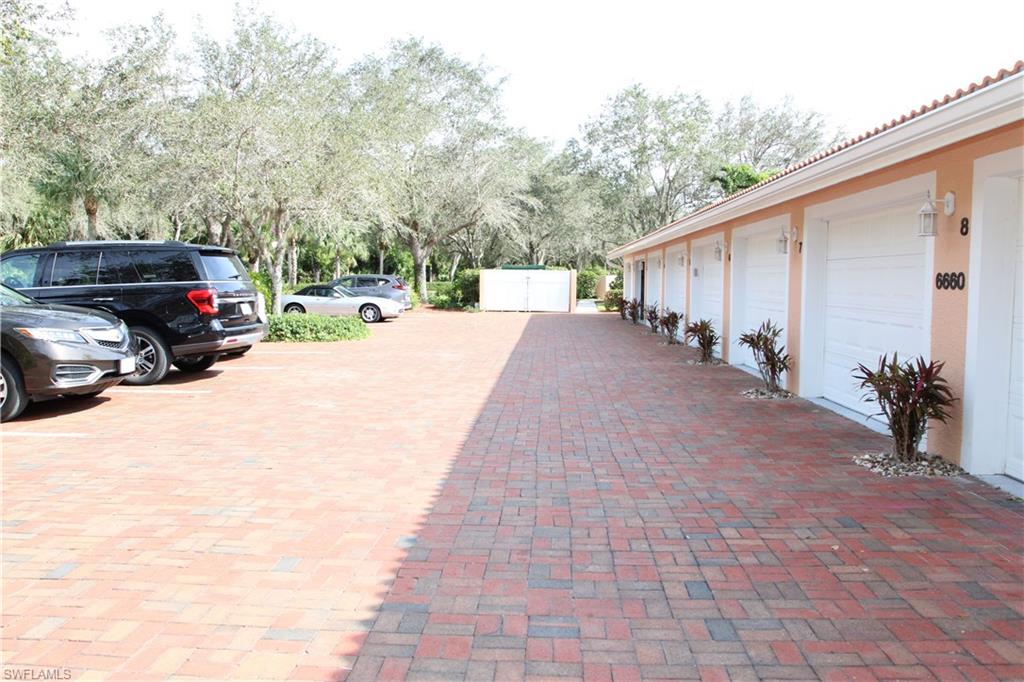 6660 Beach Resort Drive, Unit 1005 Naples, FL 34114 - Photo 36 of 38 a car parked in front of a house