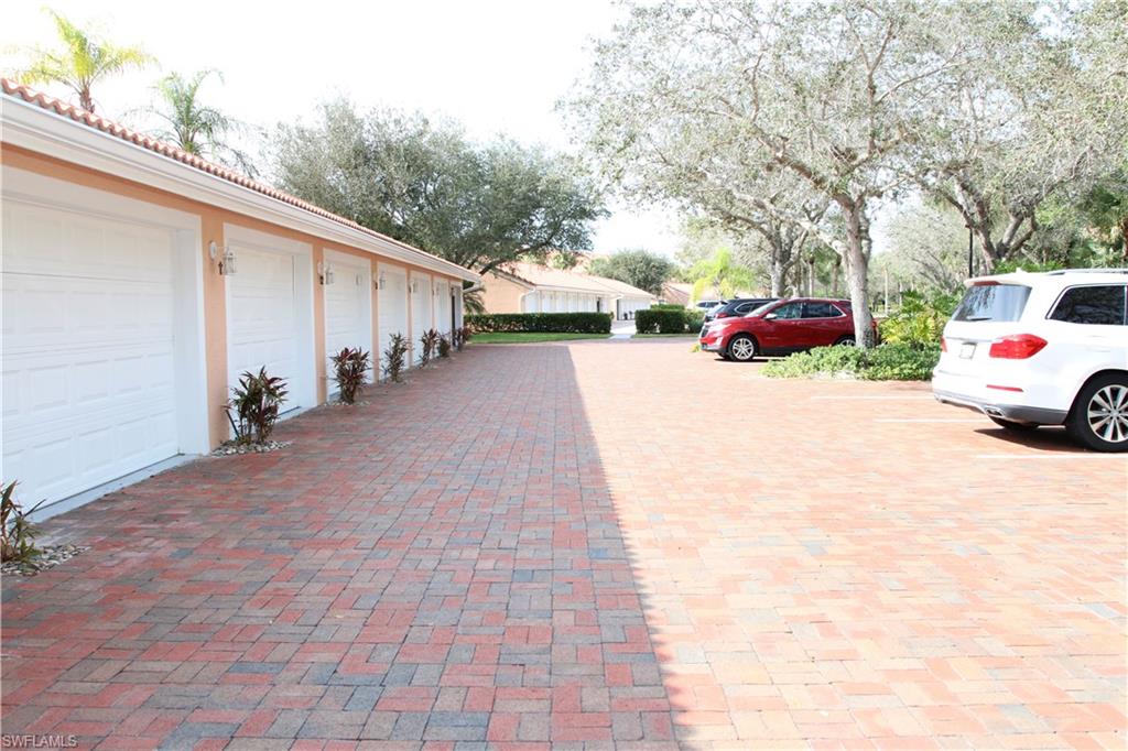 6660 Beach Resort Drive, Unit 1005 Naples, FL 34114 - Photo 37 of 38 a view of a car park in front of a house