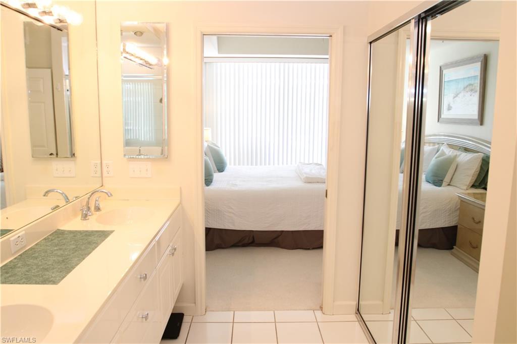 6660 Beach Resort Drive, Unit 1005 Naples, FL 34114 - Photo 6 of 38 a en suite bathroom with a granite countertop sink and a bathtub