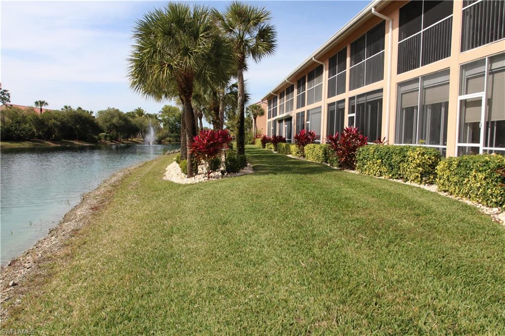 6660 Beach Resort Drive, Unit 1005 Naples, FL 34114 - Photo 10 of 38 a view of swimming pool with a garden and trees