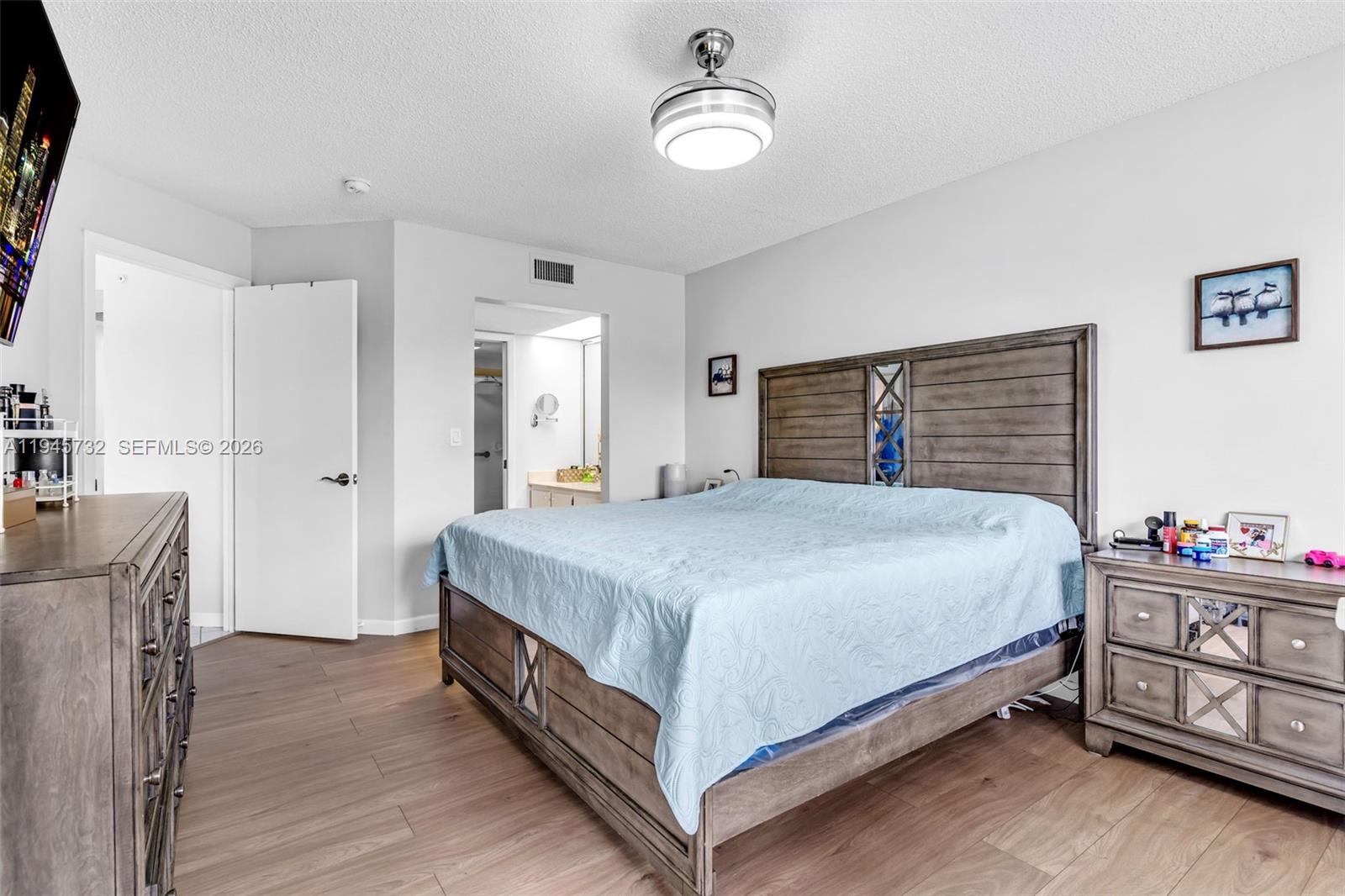 2520 Southeast 20th Place, Unit 204B Homestead, FL 33035 - Photo 13 of 45 a spacious bedroom with a bed and a dresser