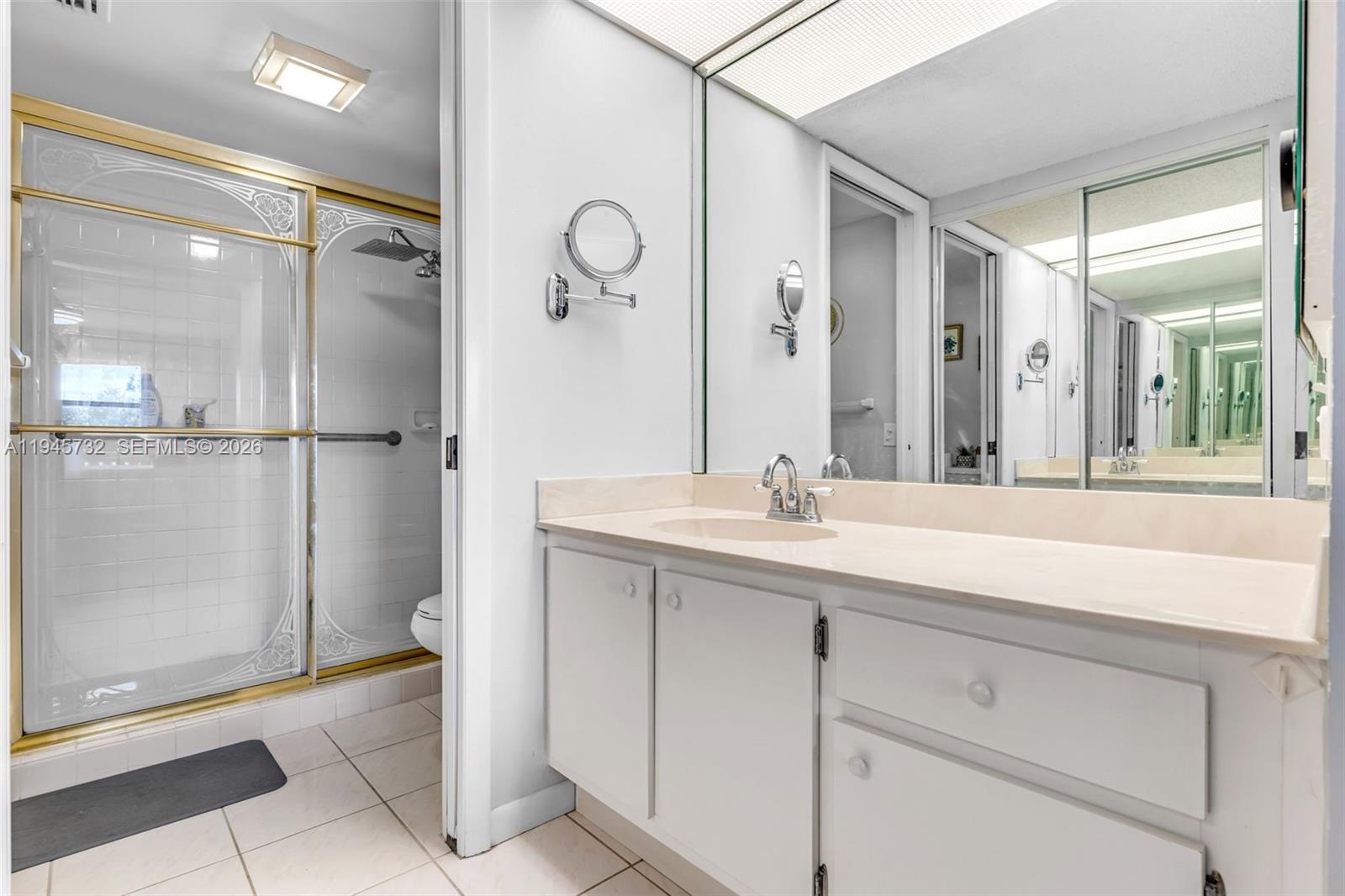 2520 Southeast 20th Place, Unit 204B Homestead, FL 33035 - Photo 14 of 45 a bathroom with a double vanity sink mirror and shower