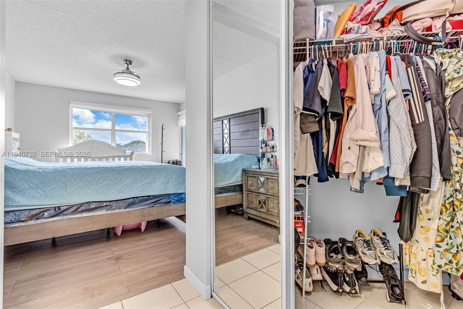 2520 Southeast 20th Place, Unit 204B Homestead, FL 33035 - Photo 16 of 45 a view of walk in closet with clothes and shoes