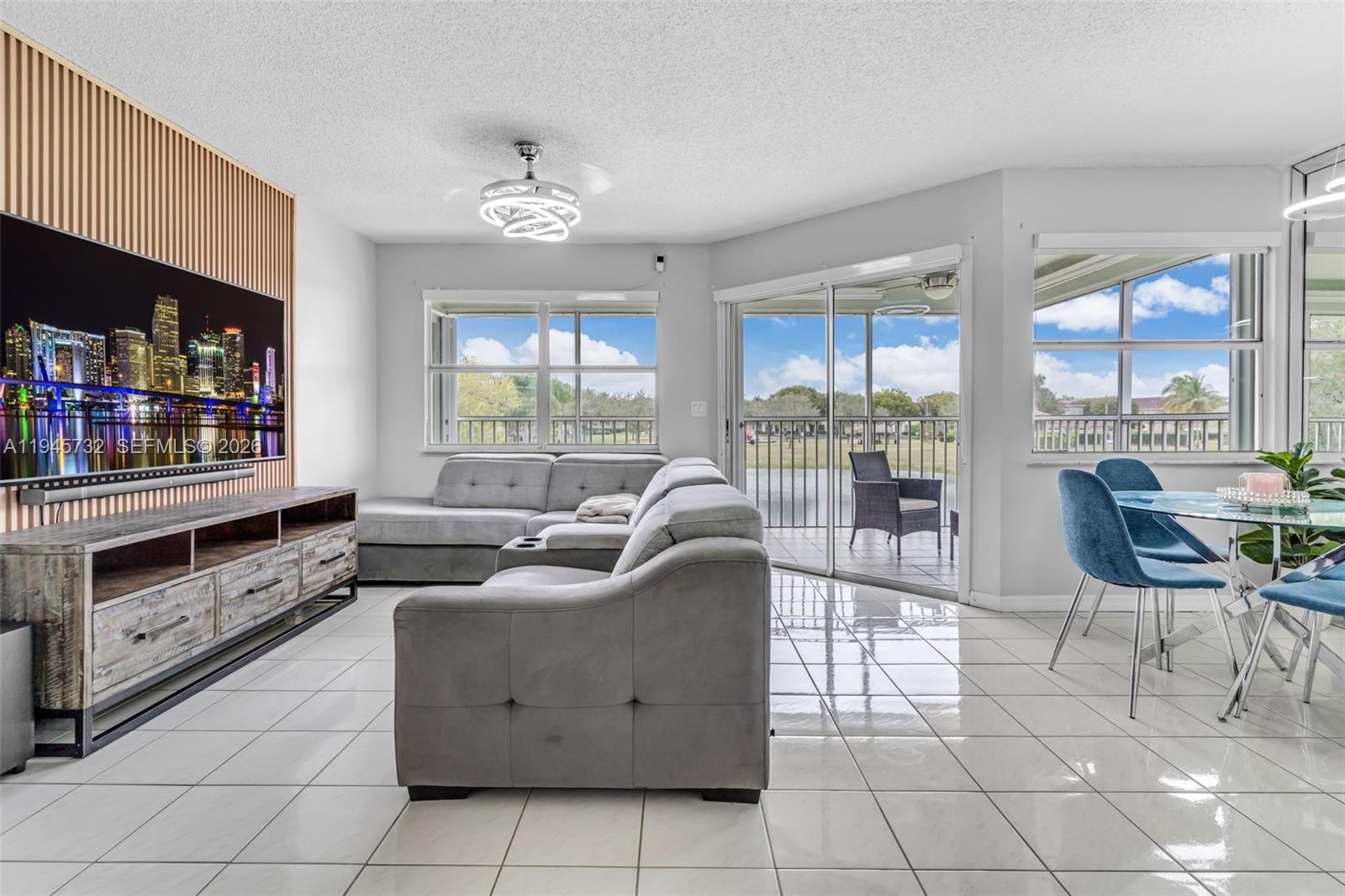 2520 Southeast 20th Place, Unit 204B Homestead, FL 33035 - Photo 4 of 45 a living room with fireplace furniture and a floor to ceiling window