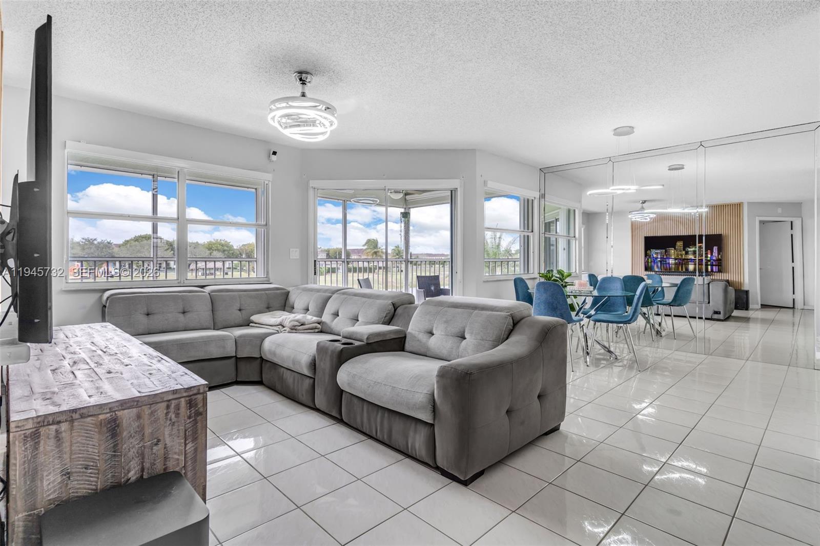2520 Southeast 20th Place, Unit 204B Homestead, FL 33035 - Photo 8 of 45 a living room with furniture and a large window