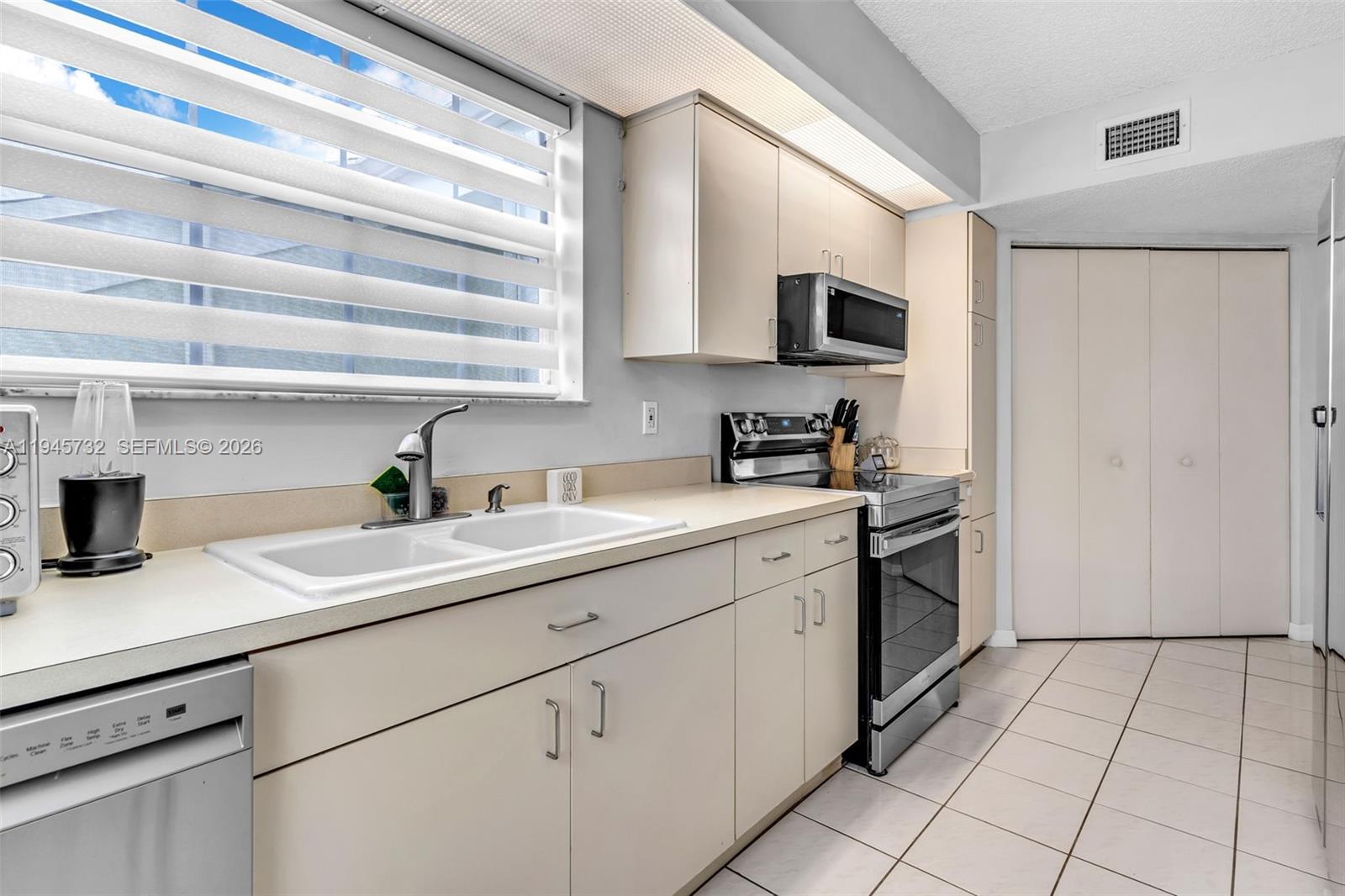 2520 Southeast 20th Place, Unit 204B Homestead, FL 33035 - Photo 10 of 45 a kitchen with a sink cabinets and appliances