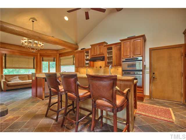 8420 Wake Forest Highway Raleigh, NC 27613 - Photo 8 of 25 Chef's Kitchen with granite countertops, double oven, electric cooktop and breakfast island. Kitchen