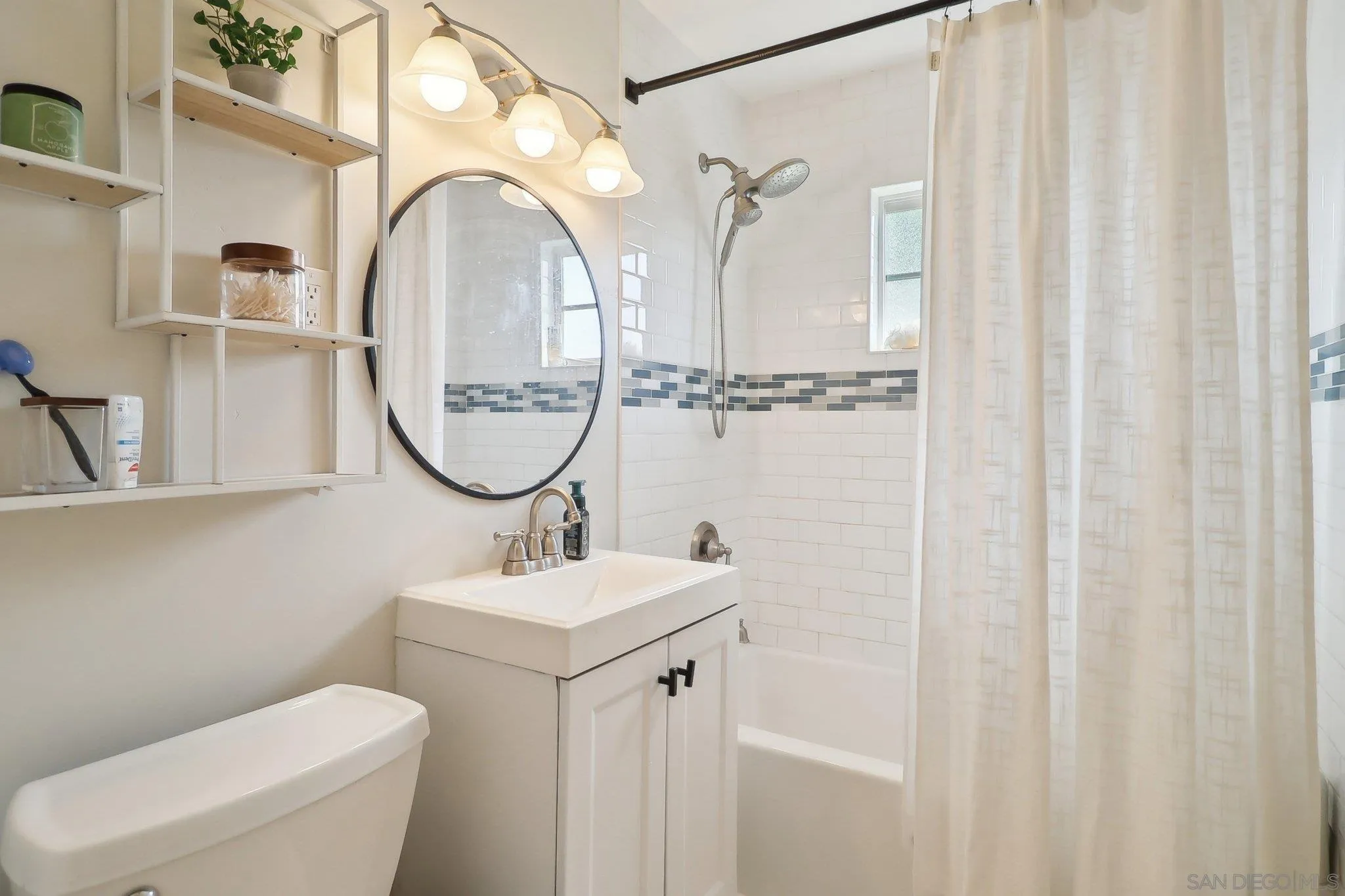 1673 Walbollen Street Spring Valley, CA 91977 - Photo 13 of 21 a bathroom with a sink mirror vanity and a toilet