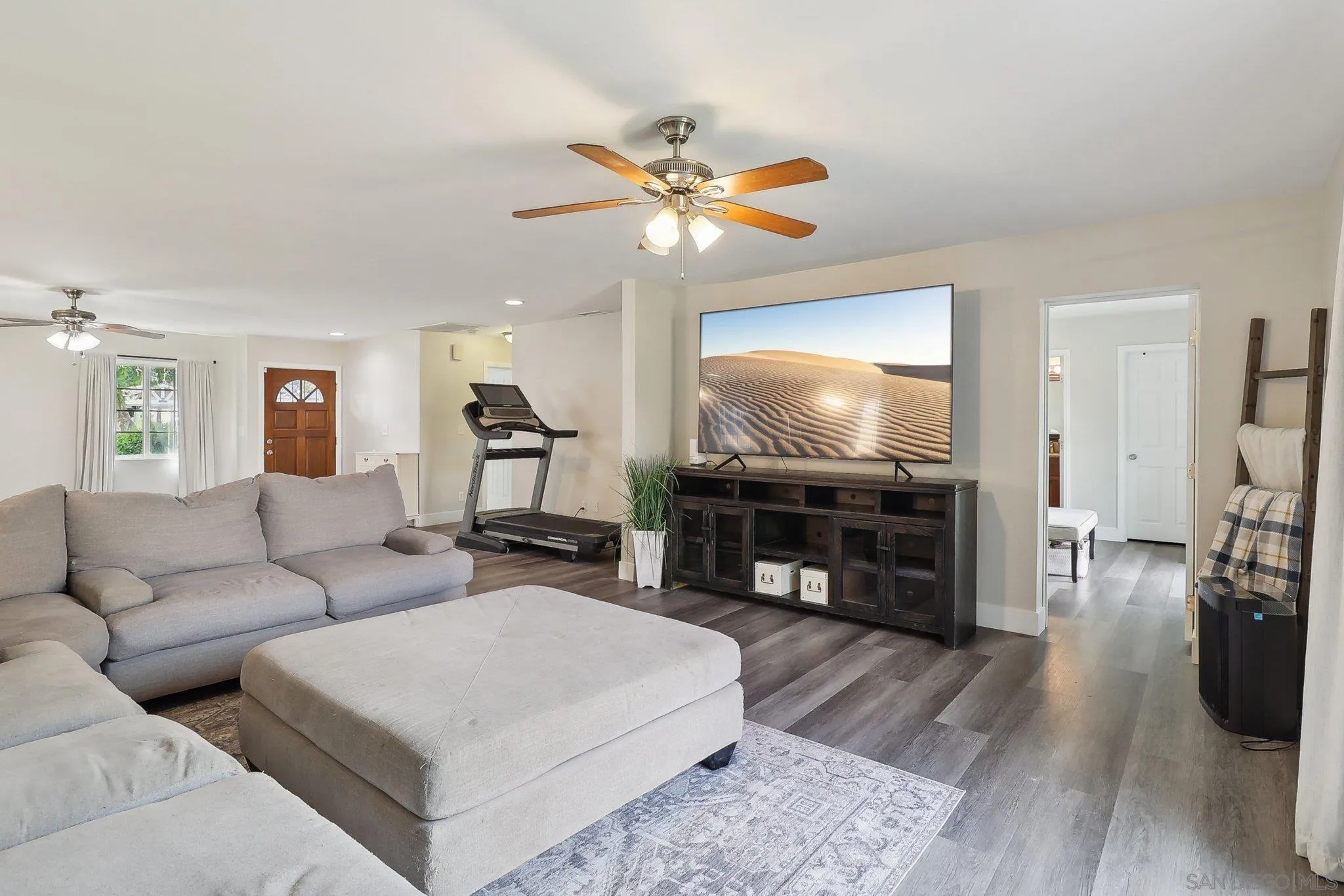1673 Walbollen Street Spring Valley, CA 91977 - Photo 3 of 21 a living room with furniture a flat screen tv and a fireplace