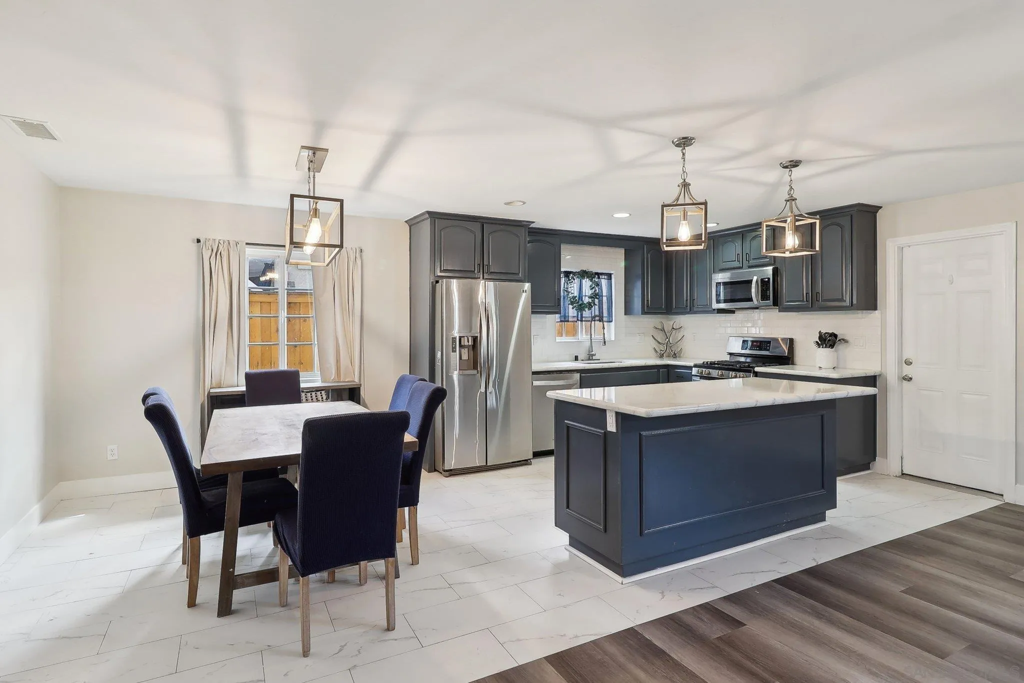 1673 Walbollen Street Spring Valley, CA 91977 - Photo 5 of 21 a large kitchen with stainless steel appliances granite countertop a stove and a refrigerator